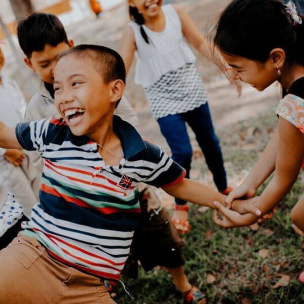 School children playing games outside together